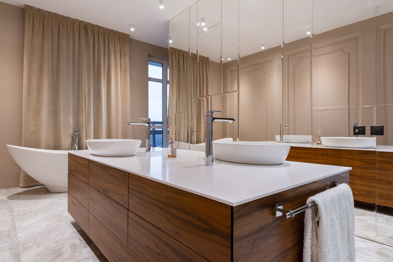 Modern bathroom with a freestanding bathtub and wood cabinetry